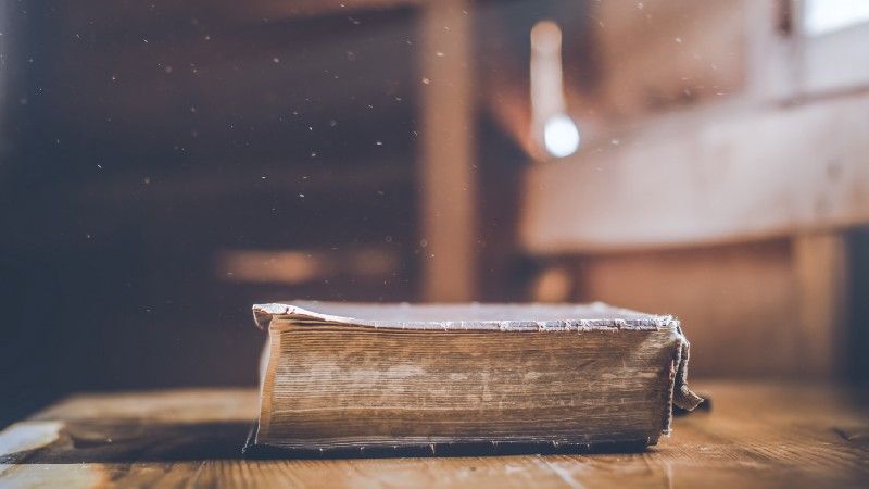 Old holy Bible on wooden table